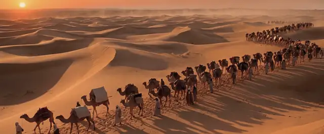 قافلة جمال طويلة في الصحراء وقت العصر